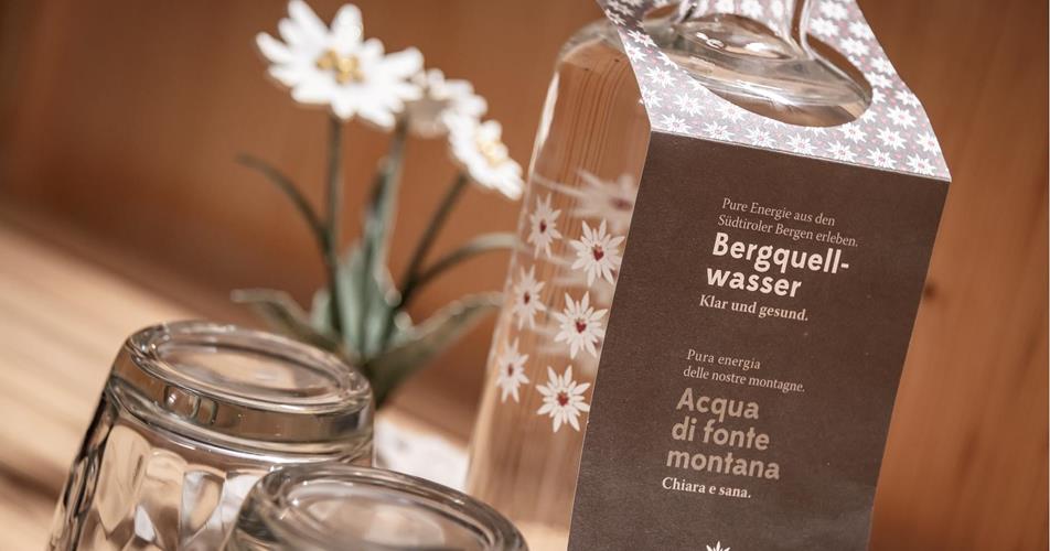 Mountain spring water bottle with two glasses