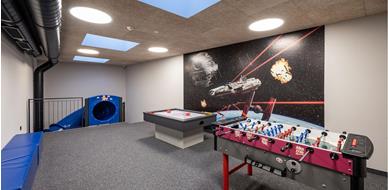 Indoor play room with an air hockey table and table football