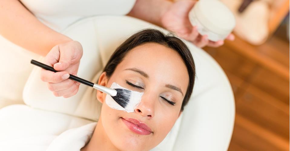 A woman is receiving a facial treatment