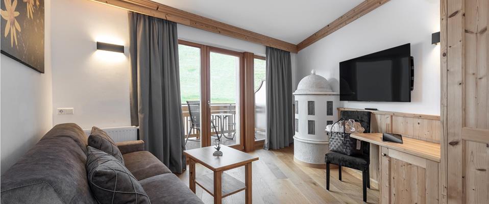 Living room with a balcony and a tiled stove