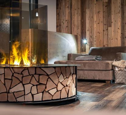 A lit fireplace in one of the relaxation rooms