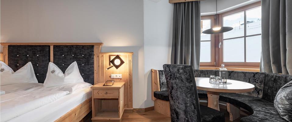 Bedroom with a double bed a bay window seating area