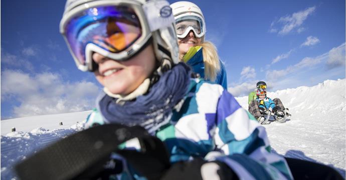 Close-up of a tobogganing family