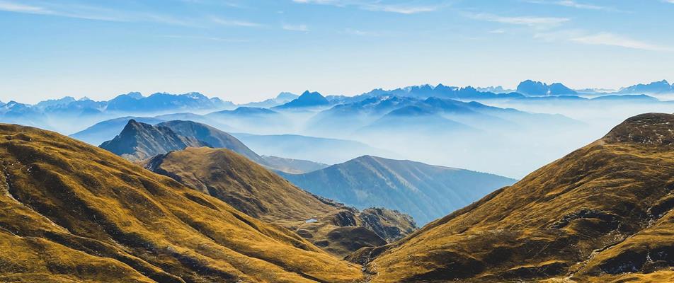 Two alpine lakes nestled among gently rolling golden slopes