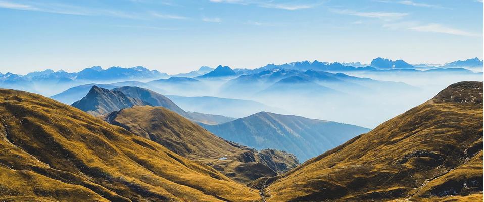 Two alpine lakes nestled among gently rolling golden slopes